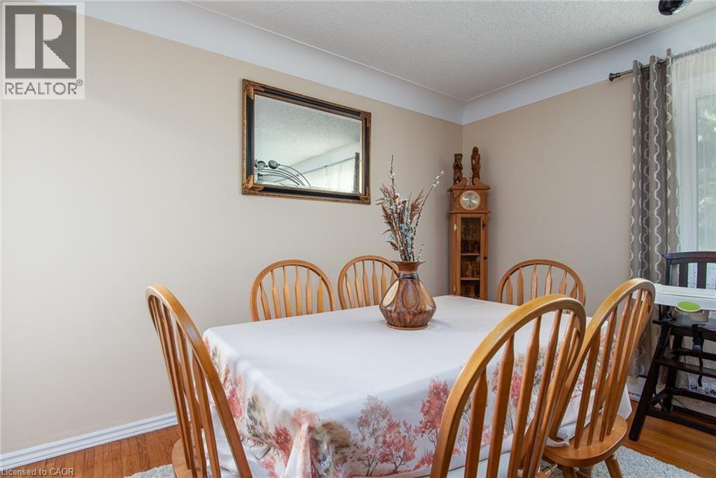 Dining space featuring light wood-style flooring and a textured ceiling - 129 River Road E, Kitchener, ON - Indoor Photo Showing Dining Room