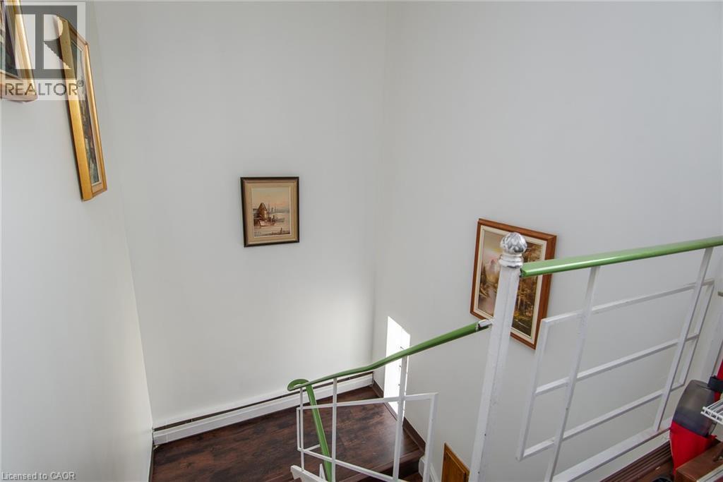 Stairs with a baseboard radiator and wood finished floors - 129 River Road E, Kitchener, ON - Indoor Photo Showing Other Room