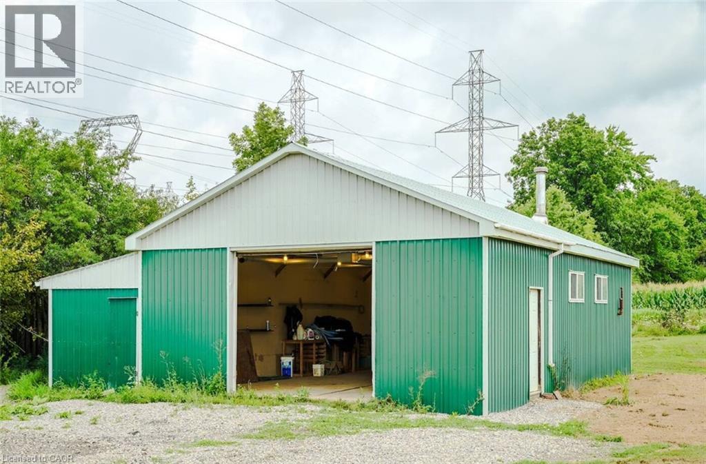 Steel-sided outbuilding with a gable roof and roll-up door - 107 6Th Line Line, Caledonia, ON - Outdoor