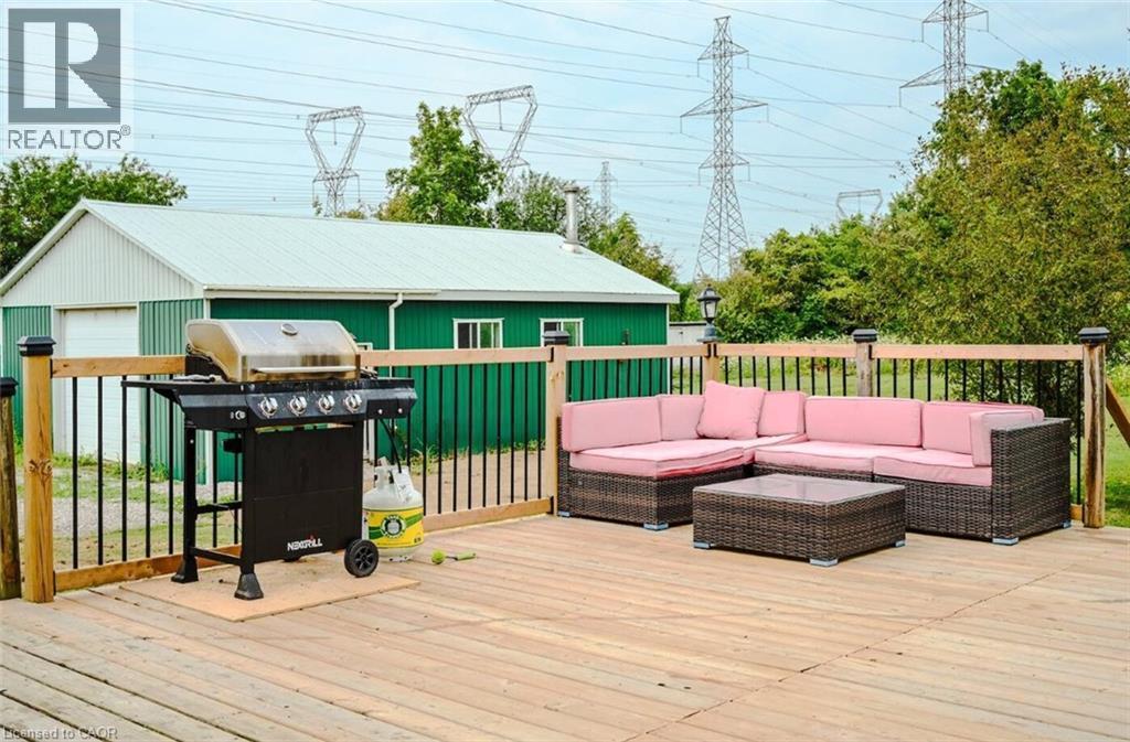 Expansive outdoor wood deck with black metal railings - 107 6Th Line Line, Caledonia, ON - Outdoor With Deck Patio Veranda With Exterior