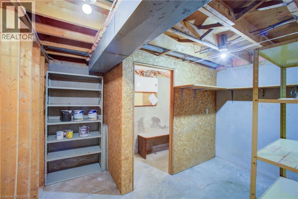Exposed wood framing, multiple overhead light fixtures, and built-in shelving units - 52 Queenston Crescent, Kitchener, ON - Indoor