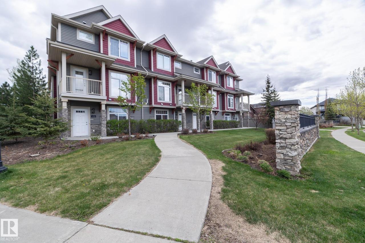 Contemporary multi-story townhome with a distinctive red and gray exterior - 117 Callaghan Drive Sw, Edmonton, AB - Outdoor With Facade