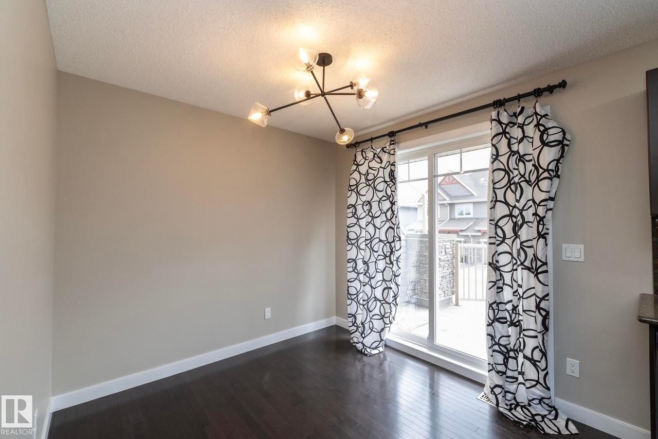 Sliding glass door providing exterior access - 117 Callaghan Drive Sw, Edmonton, AB - Indoor Photo Showing Other Room