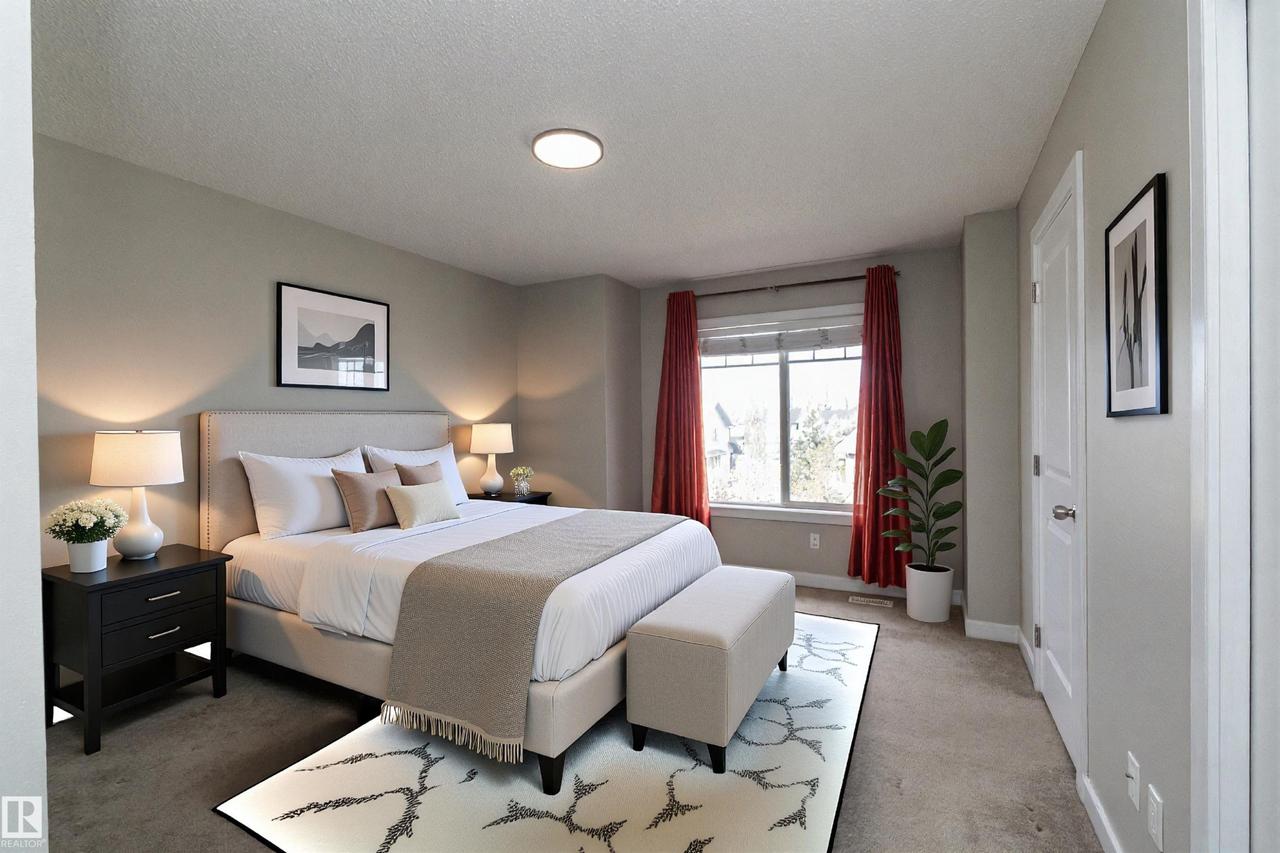 Bedroom featuring a neutral color palette, ceiling-mounted light fixture, window with red drapery, and a white six-panel interior door - 117 Callaghan Drive Sw, Edmonton, AB - Indoor Photo Showing Bedroom