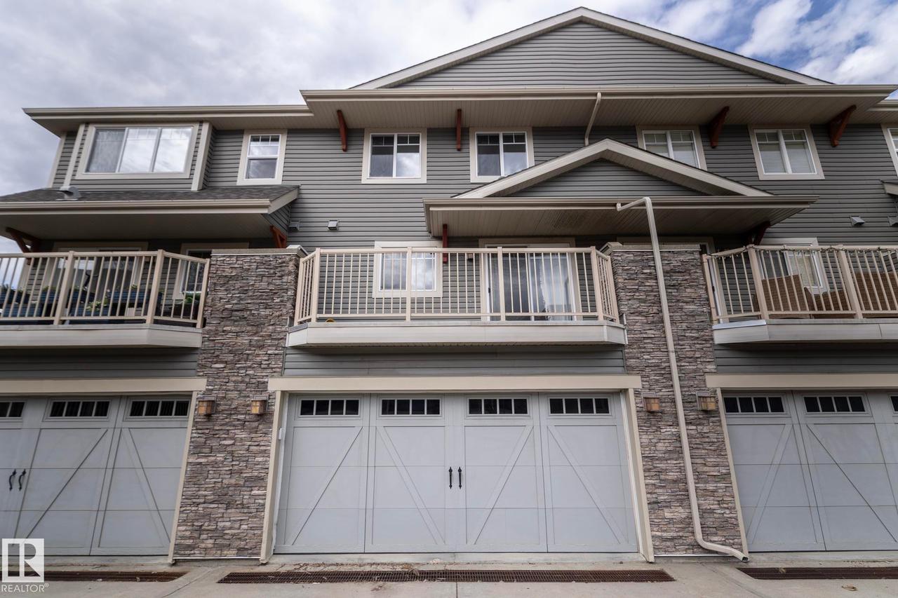 Multi-level exterior featuring horizontal siding and stone veneer accents - 117 Callaghan Drive Sw, Edmonton, AB - Outdoor