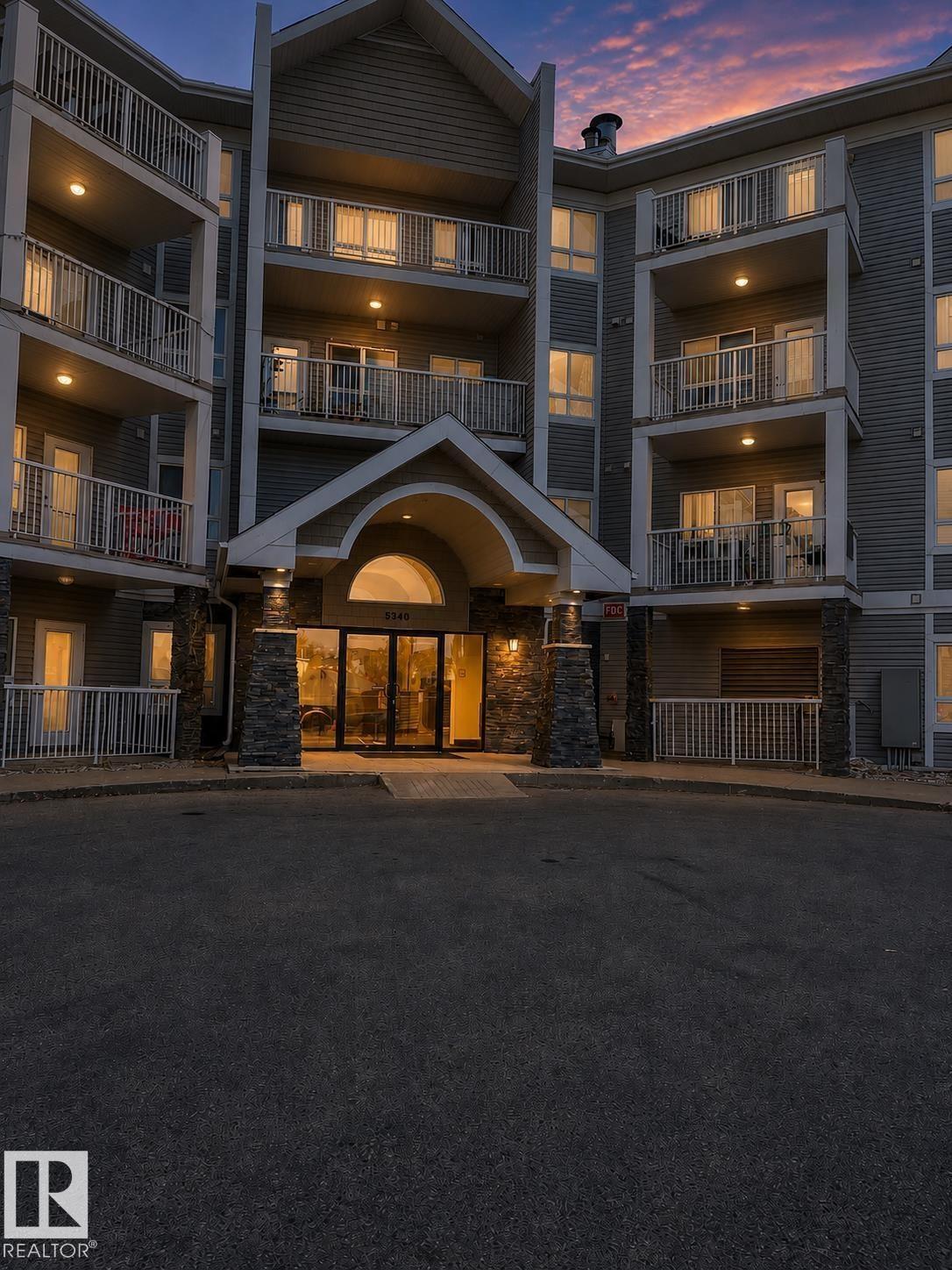 Multi-story residential building featuring balconies with white railings - #115 5340 199 St Nw, Edmonton, AB - Outdoor
