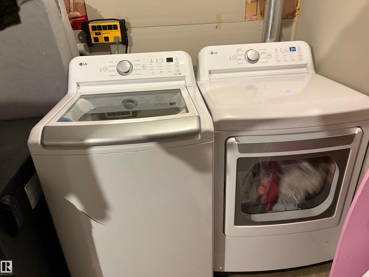 White top-load washer and front-load dryer set, featuring digital controls and a clear washer lid - #184 1804 70 St Sw, Edmonton, AB - Indoor Photo Showing Laundry Room
