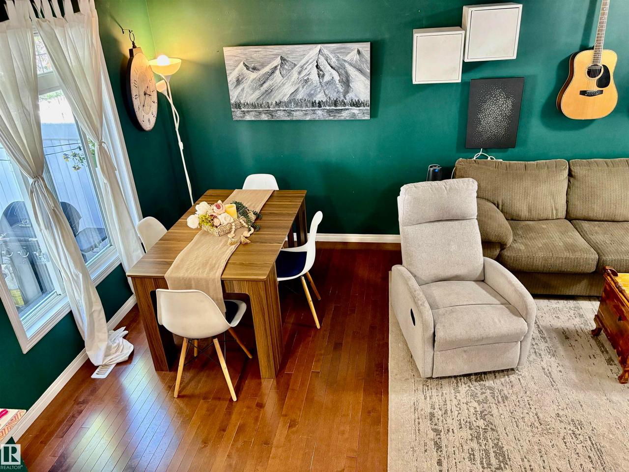 Dining area with wood-finish flooring and a rectangular dining table - #184 1804 70 St Sw, Edmonton, AB - Indoor