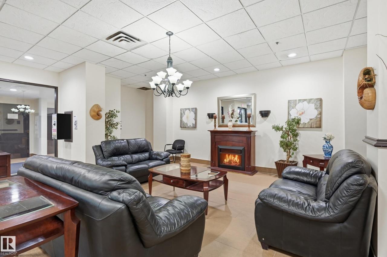 #200 10149 Saskatchewan Dr Nw, Edmonton, AB - Indoor Photo Showing Living Room With Fireplace
