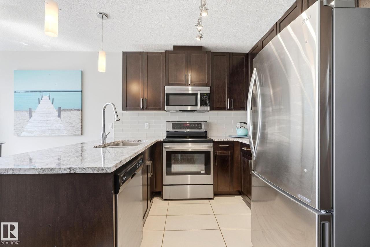#125 5151 Windermere Boulevard Sw, Edmonton, AB - Indoor Photo Showing Kitchen With Stainless Steel Kitchen With Upgraded Kitchen
