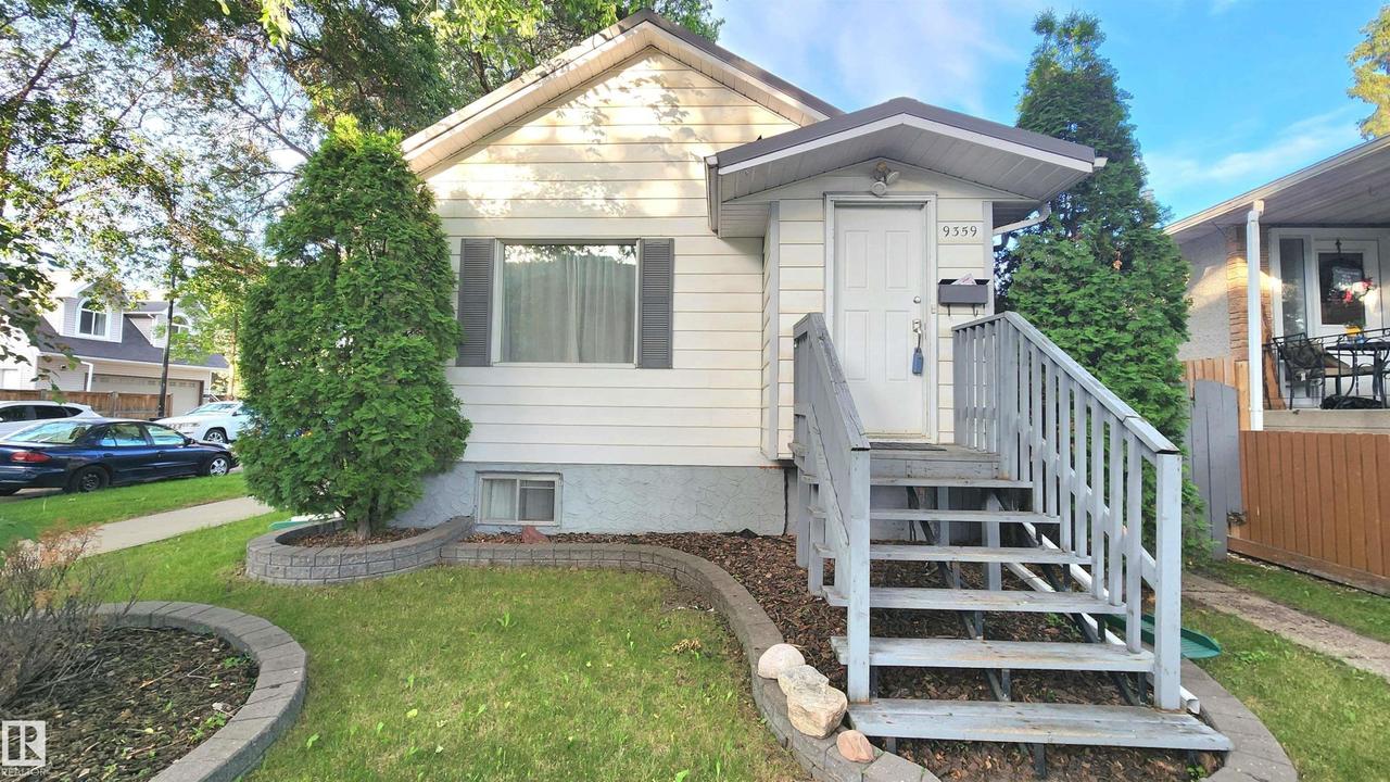 White siding exterior with a dark grey painted wood-finish deck and railings - 9359 92 Street Nw, Edmonton, AB - Outdoor