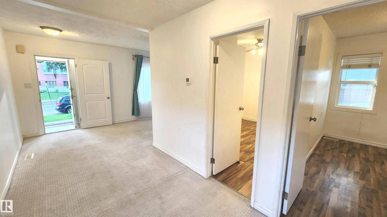 Carpeted entryway with a flush mount light fixture - 9359 92 Street Nw, Edmonton, AB - Indoor Photo Showing Other Room