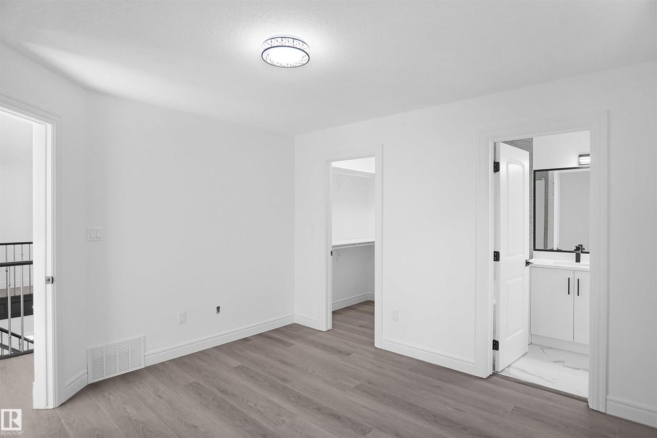 Bright interior with wood-finish flooring - 6823 18 Avenue Sw, Edmonton, AB - Indoor Photo Showing Other Room