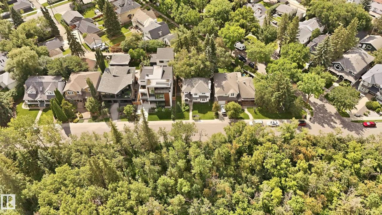 Residential street lined with mature trees and diverse architectural styles - 14631 Summit Drive Nw, Edmonton, AB - Outdoor With View