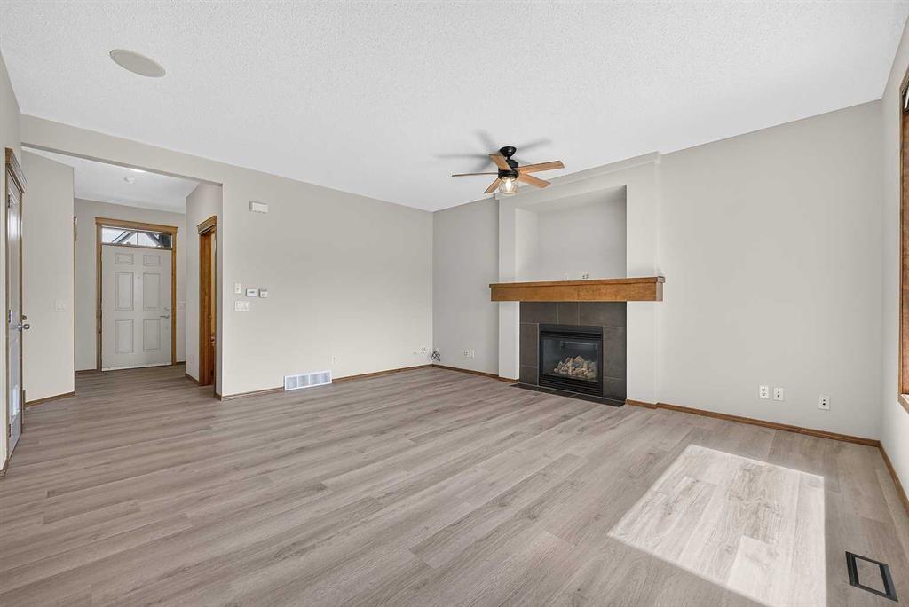 249 Elgin Manor Se, Calgary, AB - Indoor Photo Showing Living Room With Fireplace
