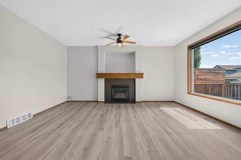 249 Elgin Manor Se, Calgary, AB - Indoor Photo Showing Living Room With Fireplace