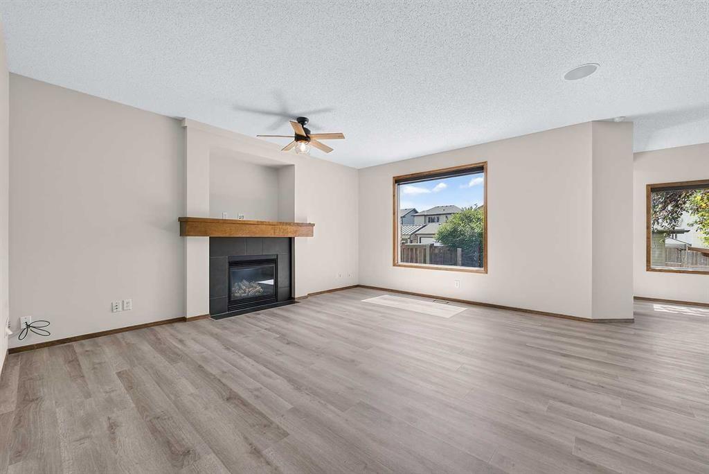249 Elgin Manor Se, Calgary, AB - Indoor Photo Showing Living Room With Fireplace