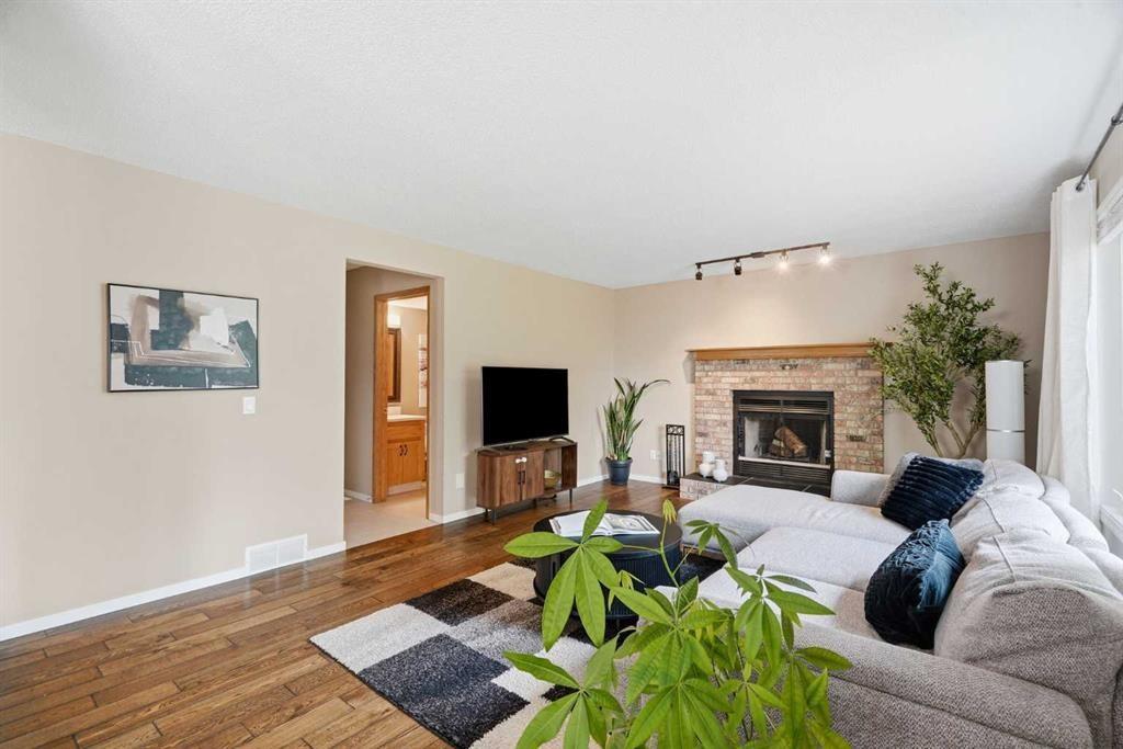 515 Macewan Drive Nw, Calgary, AB - Indoor Photo Showing Living Room With Fireplace